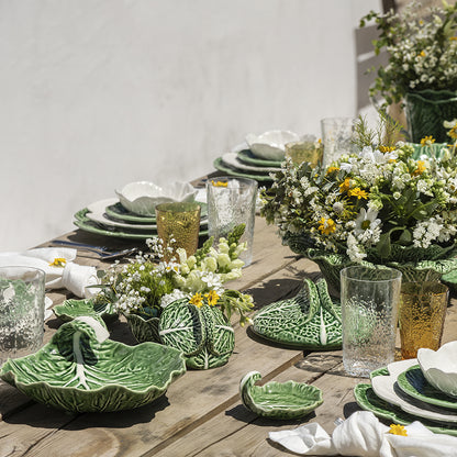 Bordallo Pinheiro Cabbage Chip & Dip Bowl-Outdoor table setting with green ceramic plates and floral decorations.