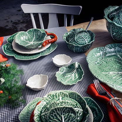 Bordallo Pinheiro Cabbage Chip & Dip Bowl-Green ceramic cabbage-themed tableware on a checkered tablecloth with a dark background.