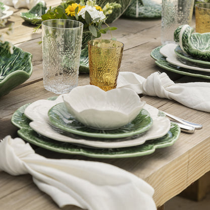 Bordallo Pinheiro Cabbage Dinner Plate-Dining table setting with green and white plates, glasses, and napkins.