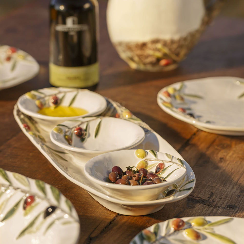 Bordallo Pinheiro Olival Small Bowl-Set of ceramic dishes with fruit patterns on a wooden table.