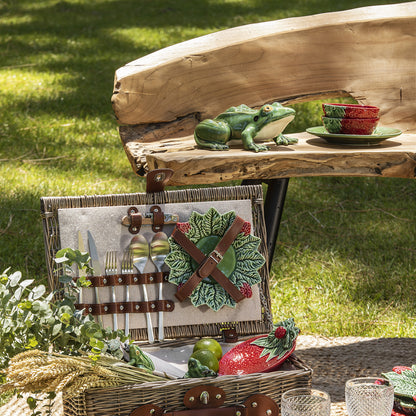 Bordallo Strawberries Bowl – Artisan Fruit Ceramic UAE-Picnic setup with a wooden bench, ceramic frog, and picnic basket on grass.