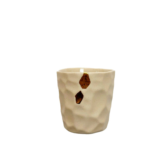 Beige fabric Cawa Cups with brown geometric patterns on a white background