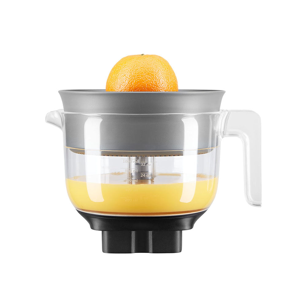 Orange being juiced with a manual juicer on a white background