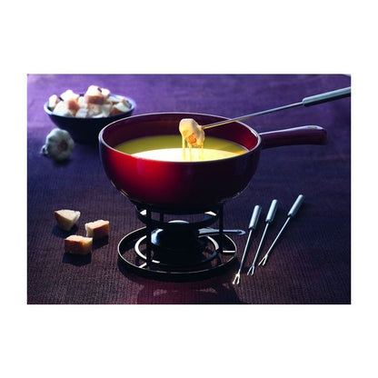 Emile Henry Fondue Set-Red fondue pot with cheese fondue, bread cubes, and fondue forks on a purple surface.