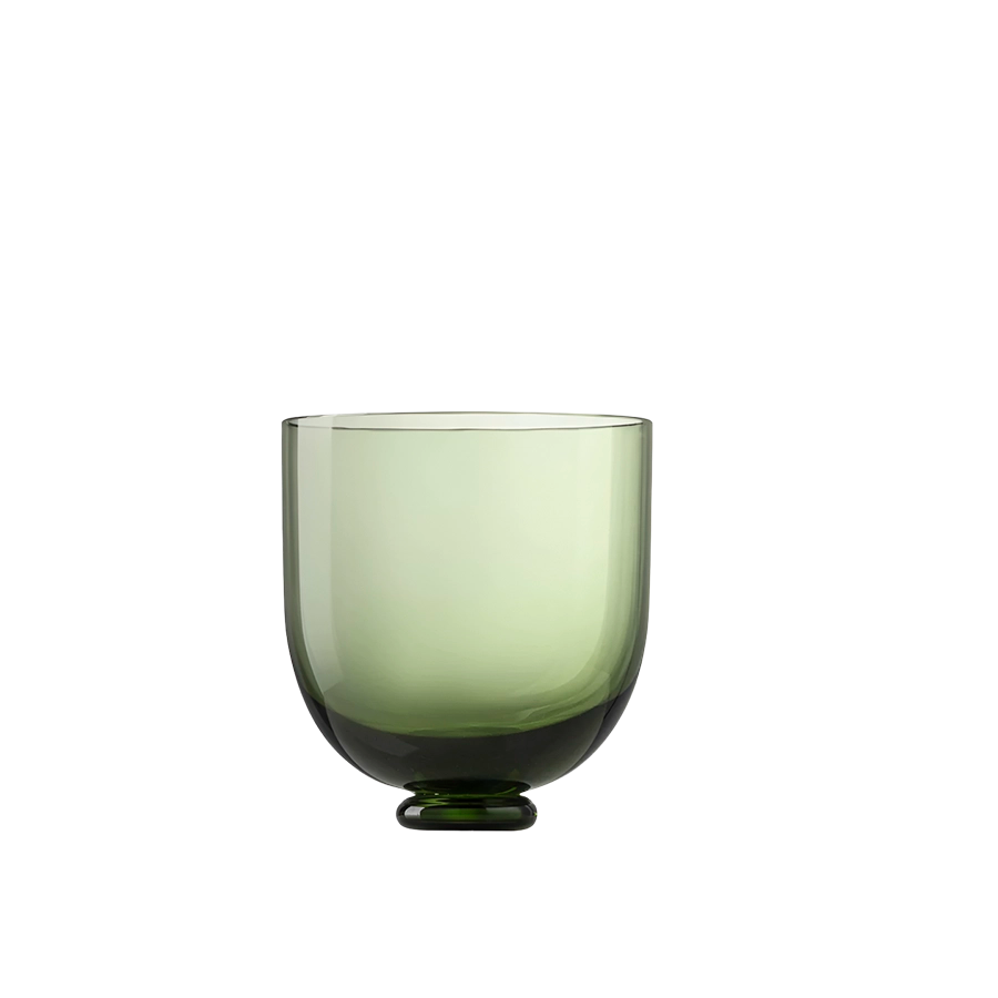 Green glass cup on a white background