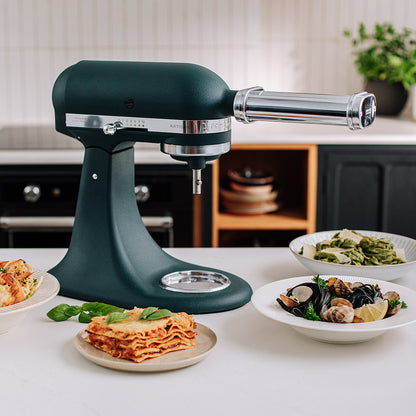 KitchenAid Green stand mixer on a kitchen counter with plates of food