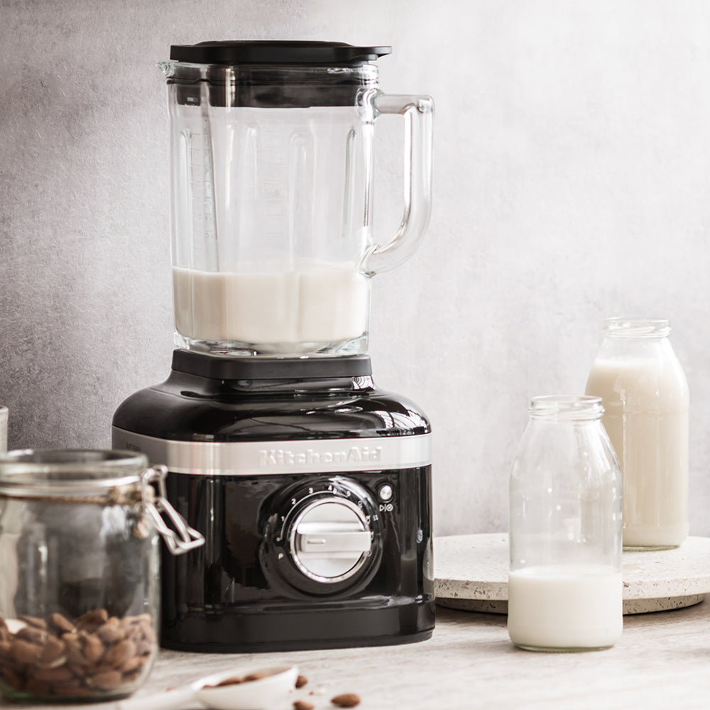 KitchenAid Black blender with a glass container filled with liquid on a kitchen counter.