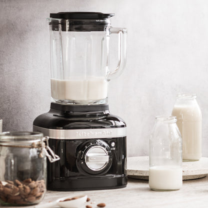 KitchenAid Black blender with a glass container filled with liquid on a kitchen counter.
