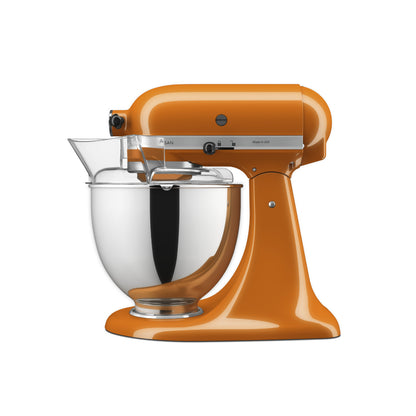 Orange stand mixer with a clear mixing bowl on a white background