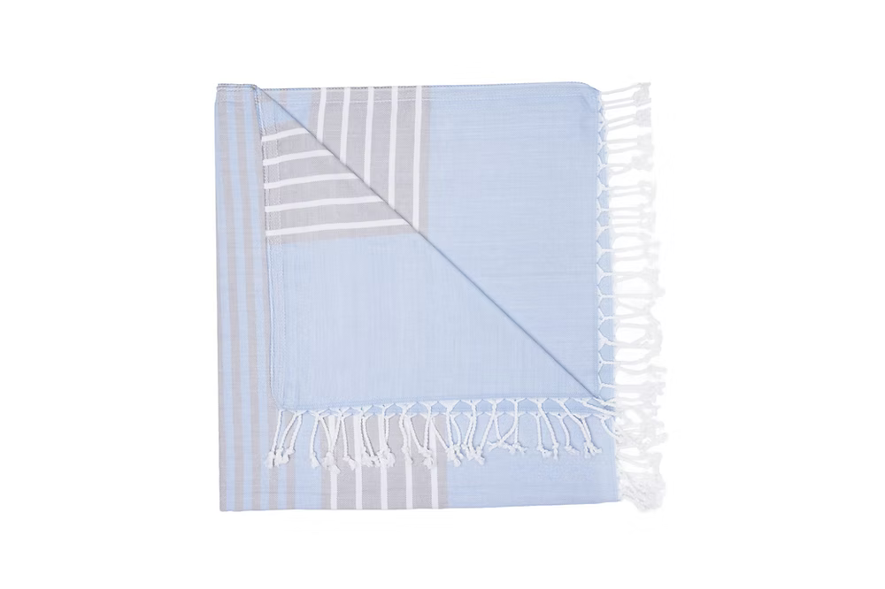 Mare Beach Towel-Light blue towel with white stripes and fringes on a white background