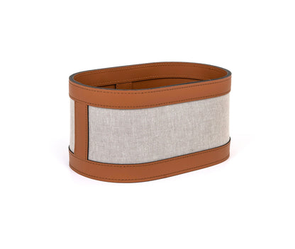 A washcloth holder with a brown leather exterior and ecru cotton layer, with a rectangular shape designed to hold washcloths or similar items.