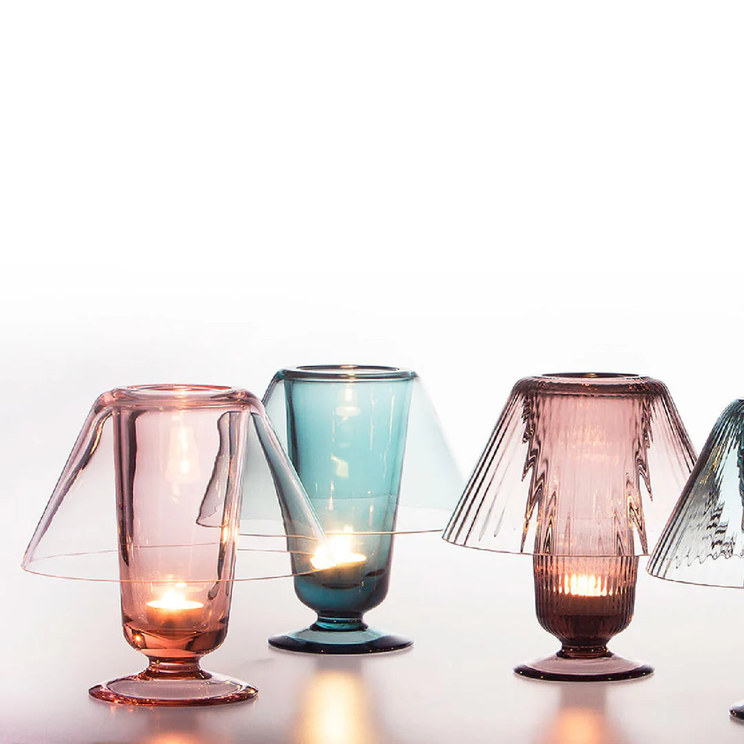 Colorful glass candle holders on a white background