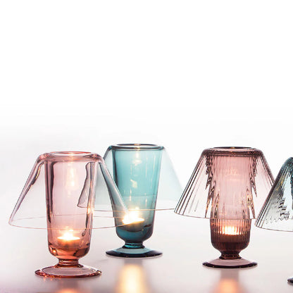 Colorful glass candle holders on a white background