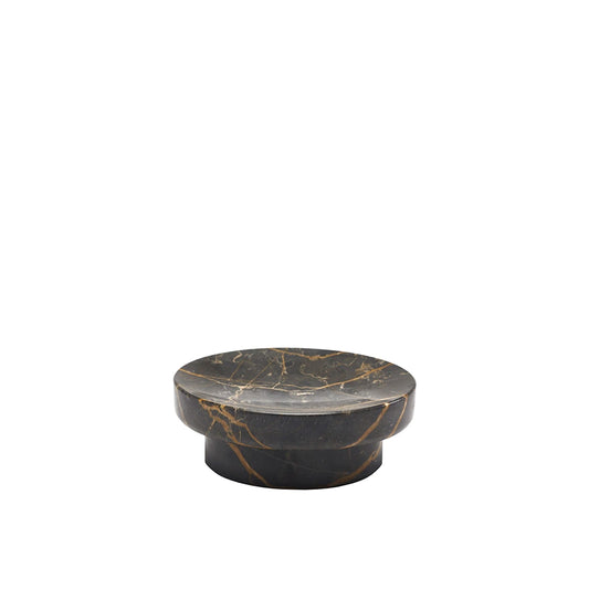 Round black marble coaster with gold veins on a white background