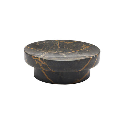 Round marble table with black and gold vein pattern on a white background