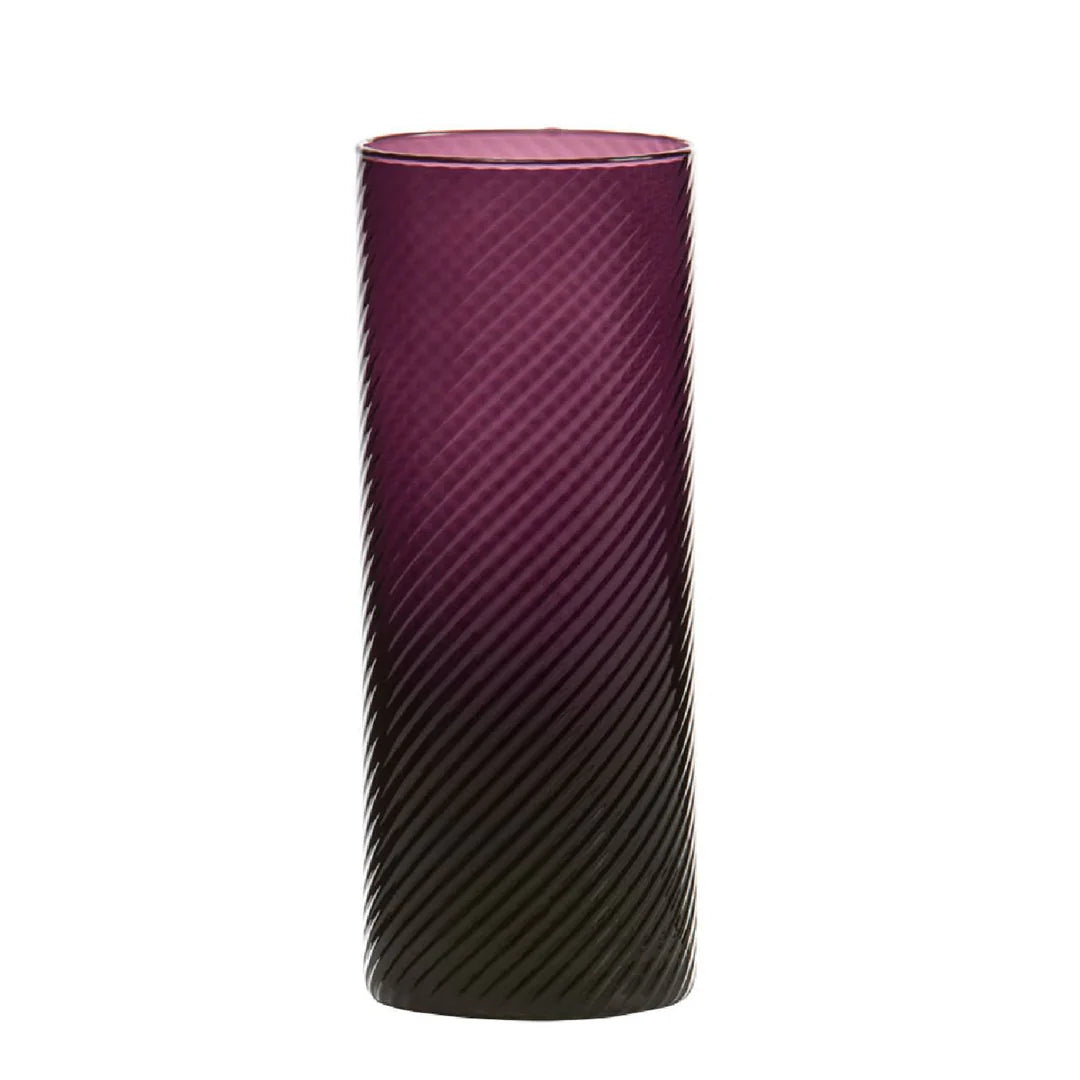 Tall cylindrical glass with purple top and black bottom on a white background