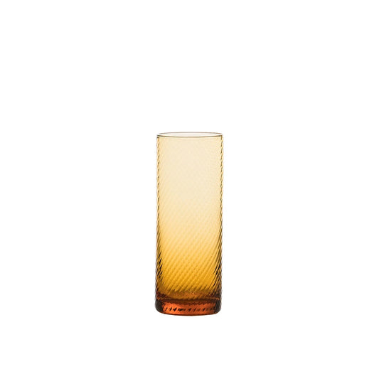 Amber glass tumbler with textured surface on a white background
