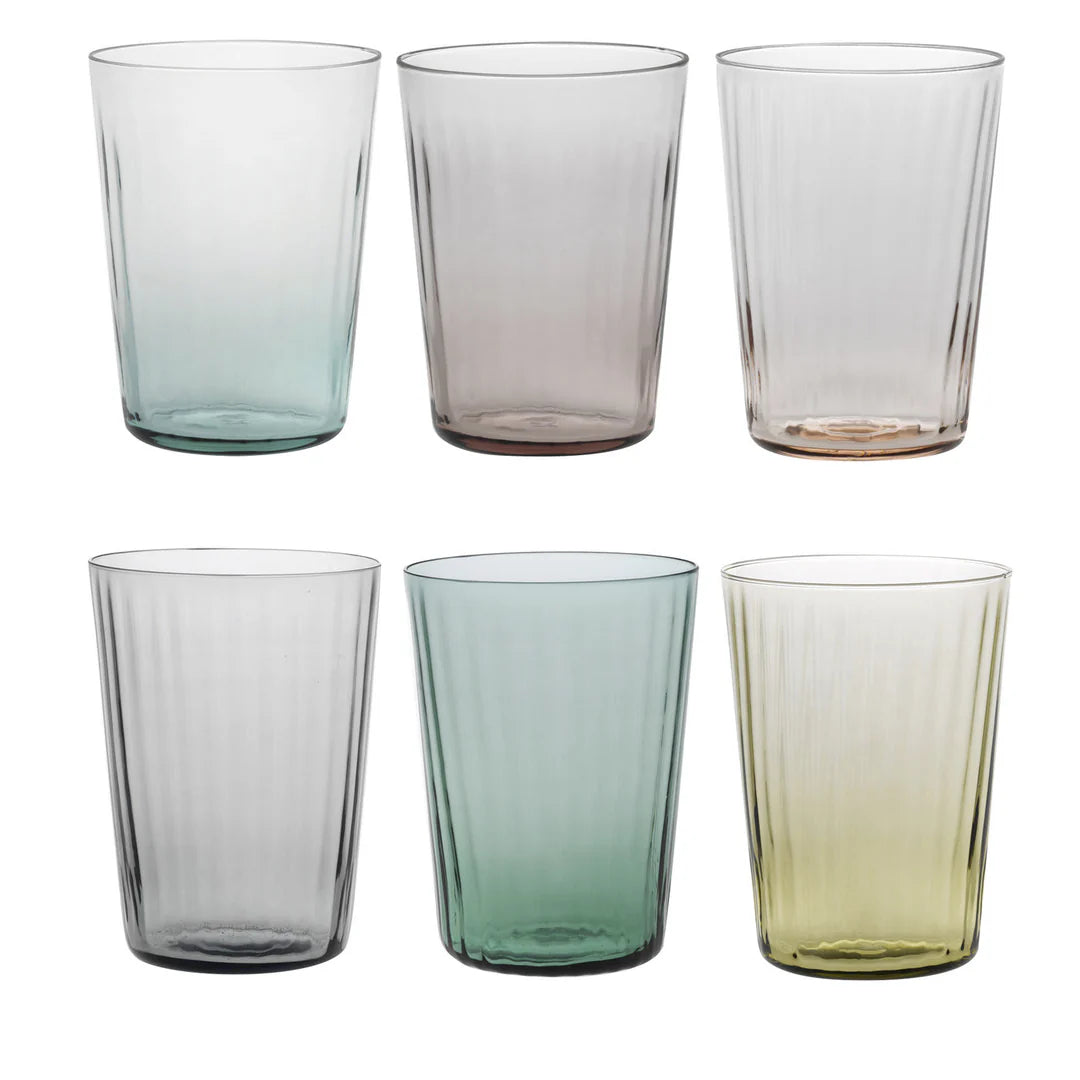 Set of six colored glass tumblers on a white background
