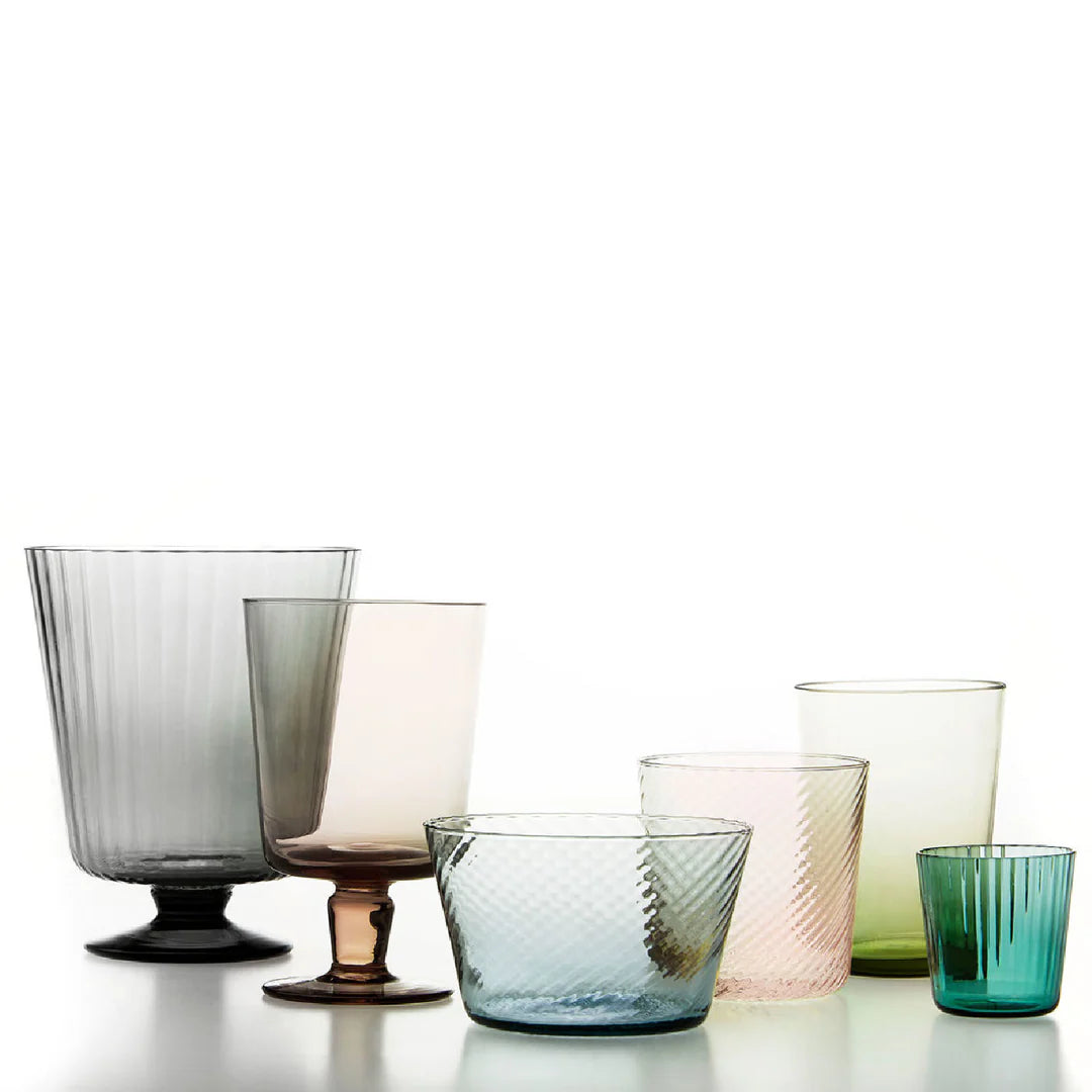 Set of colorful glass tumblers on a white background