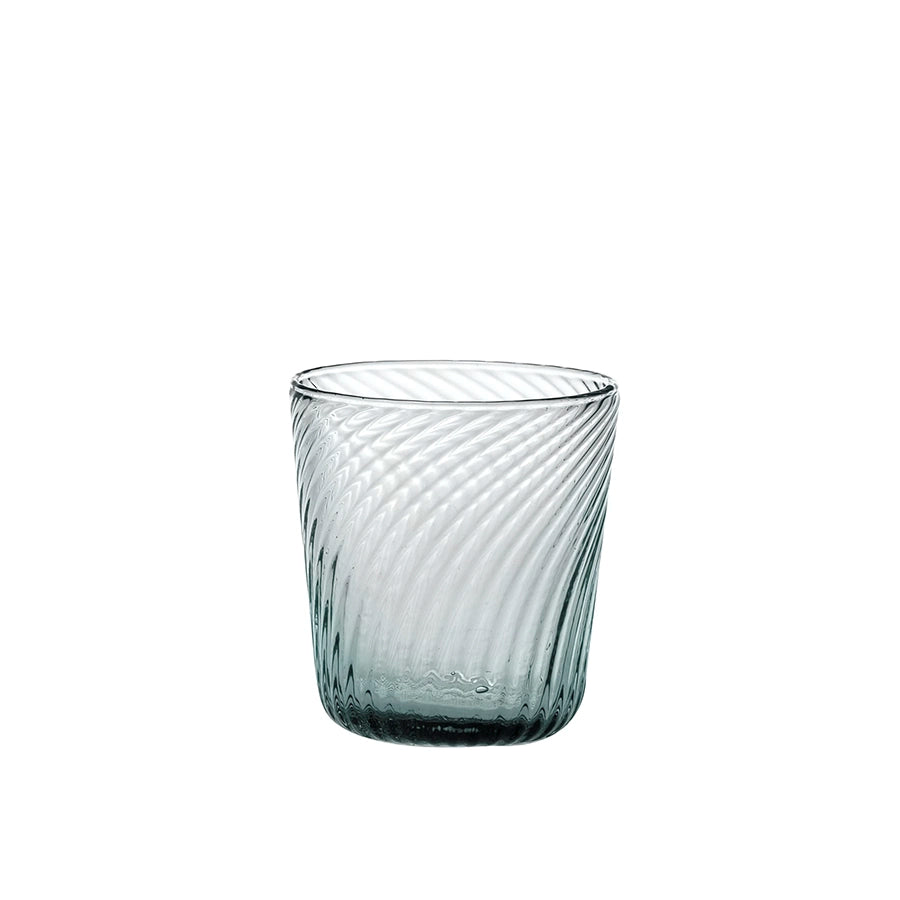 Clear glass tumbler with textured design on a white background