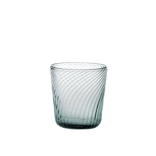 Clear glass tumbler with textured design on a white background