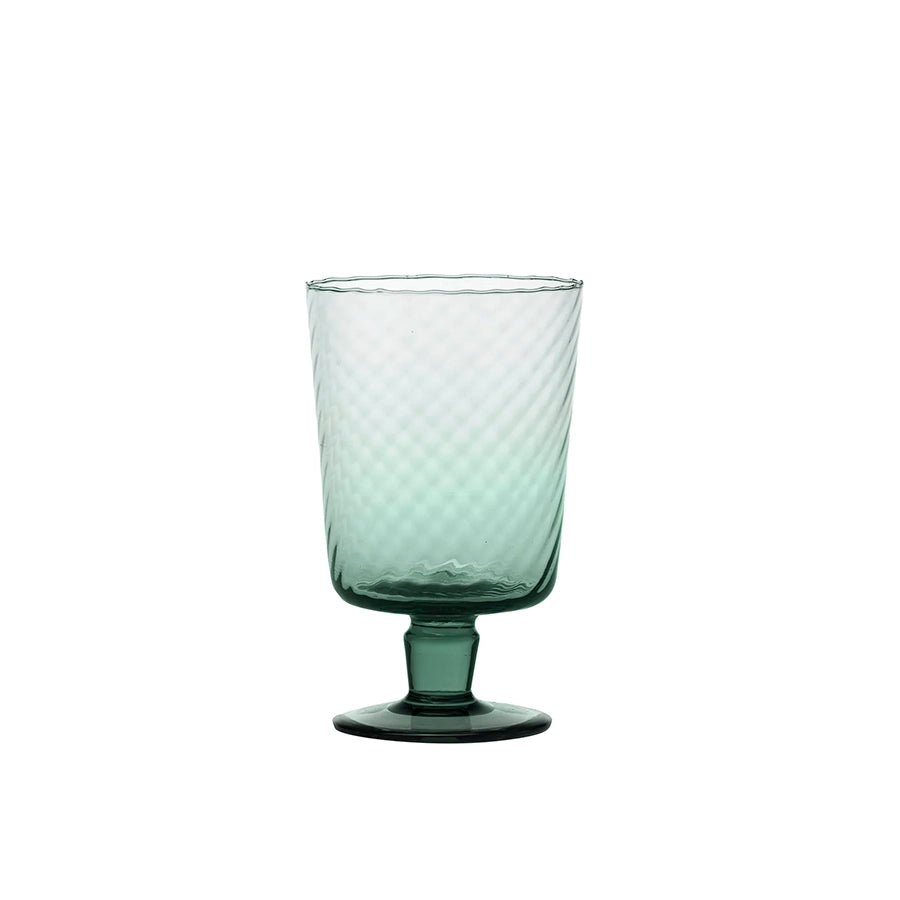 Green glass with textured design on a white background