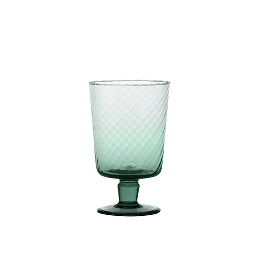 Green glass with textured design on a white background