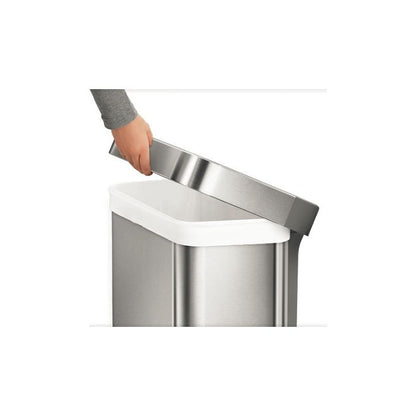 Simplehuman Rectangular Pedal Bin with Liner Pocket Stainless steel trash can with a hand lifting the lid 