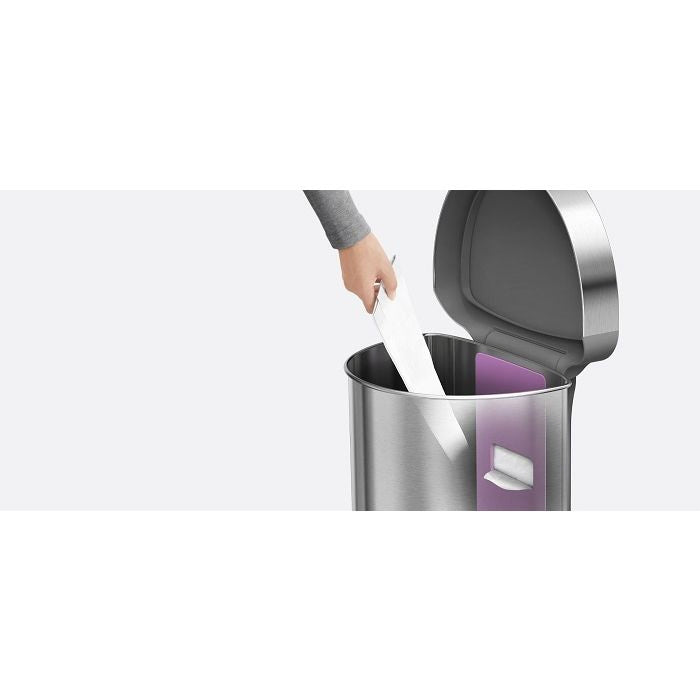 Simplehuman Semi Round Sensor Bin With Liner Pocket-Person disposing of a used pad into a trash can with a white background