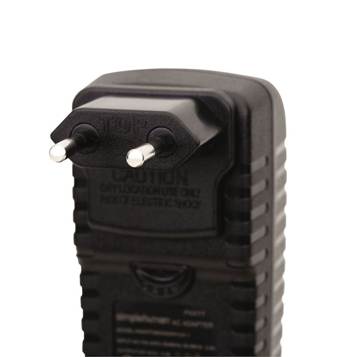 Black electrical plug with 'Caution' label 