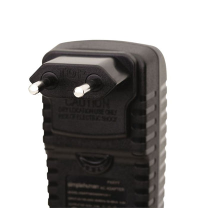 Black electrical plug with 'Caution' label 