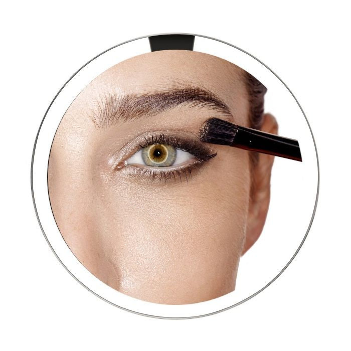 Simplehuman Sensor Mirror Fold with Travel Case-Eyebrow pencil being used on a person's eyebrow with a close-up view.