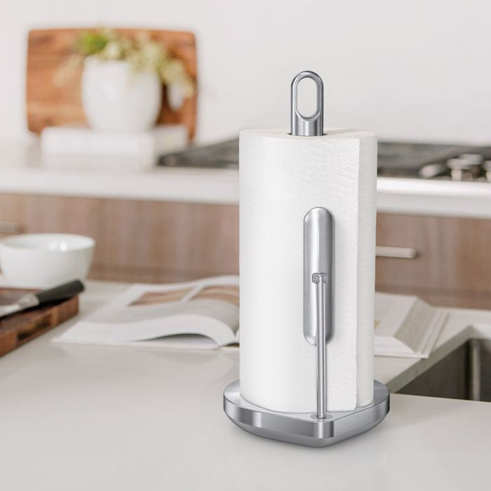 Simplehuman Tension Arm Paper Towel Holder White paper towel holder with silver base on a kitchen counter
