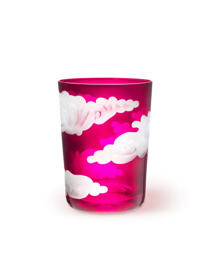 A clear glass tumbler with hand-engraved cloud designs.