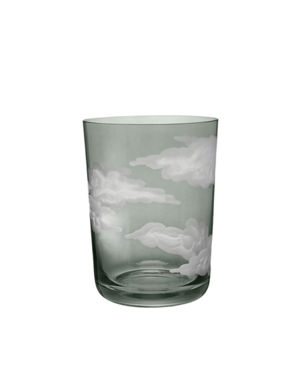 A clear glass tumbler with hand-engraved cloud designs.