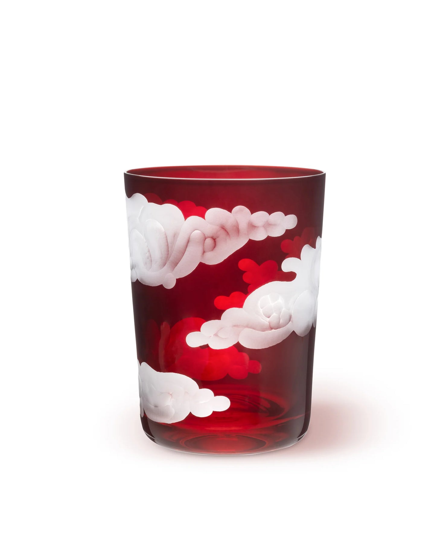 A clear glass tumbler with hand-engraved cloud designs.