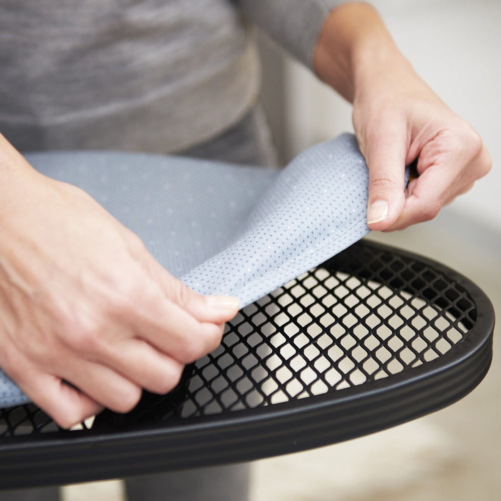 UAE laundry room-Person installing a gel seat cushion on a chair