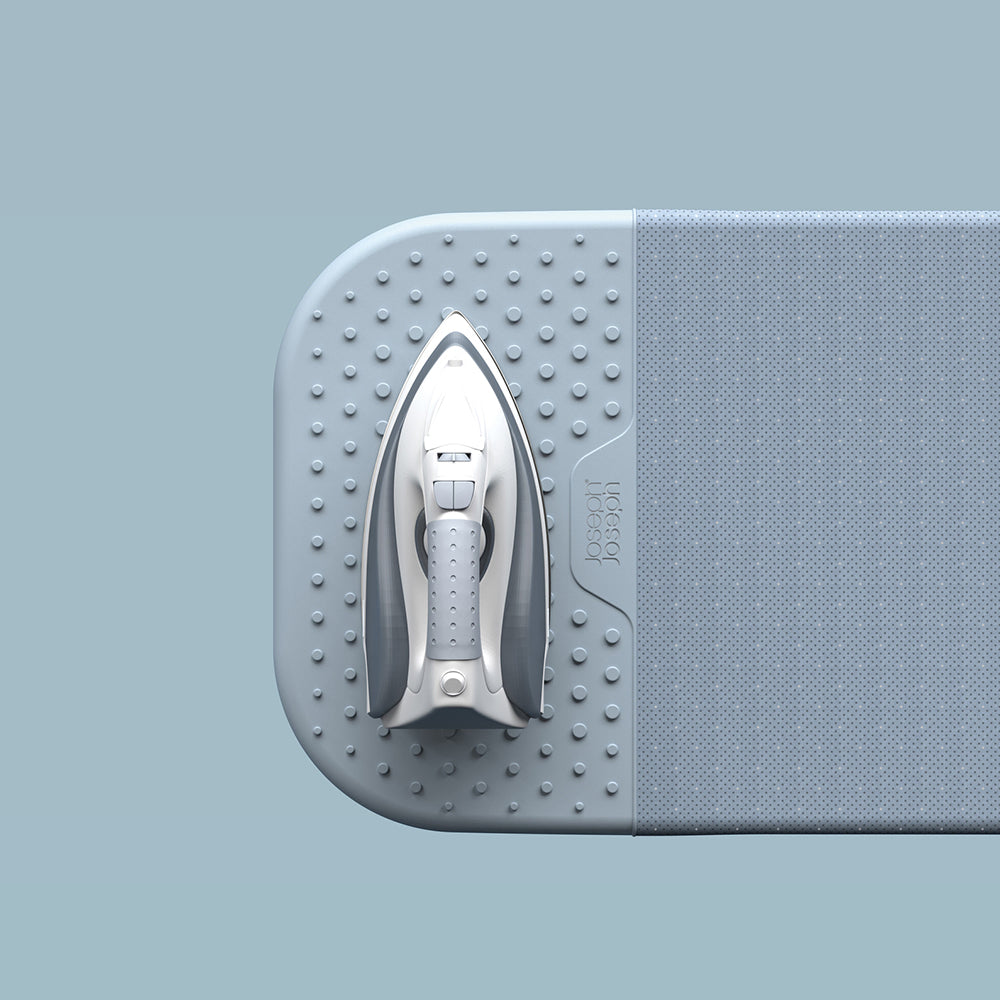 UAE laundry room-Gray ironing board with a silver iron on a light blue background
