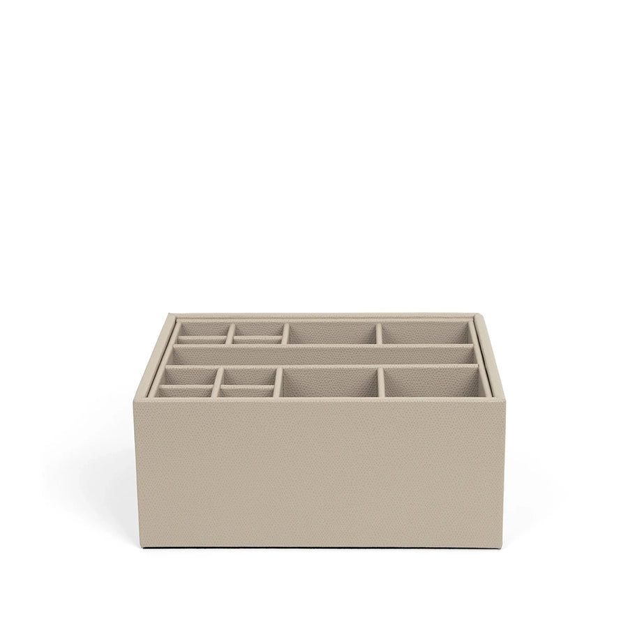 Beige jewelry organizer with multiple compartments on a white background