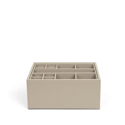 Beige jewelry organizer with multiple compartments on a white background