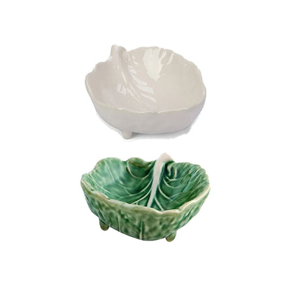 Two ceramic leaf-shaped bowls, one white and one green, on a white background.