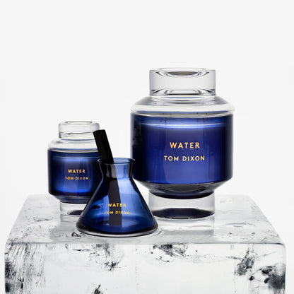 Set of Tom Dixon 'Water' candles on a marble surface