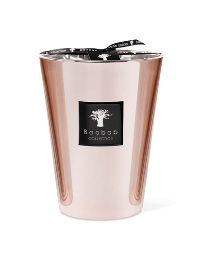 A pink metallic candle holder with a candle inside, featuring a clear glass enclosure and a black label with the brand name 'Baobab Collection'.
