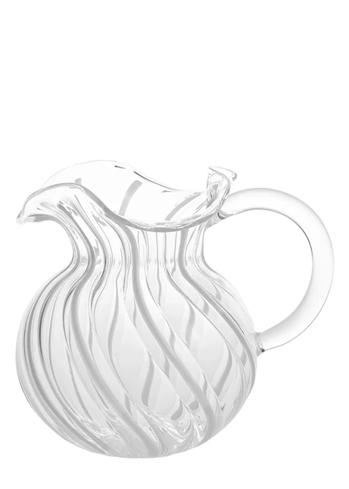 Clear glass pitcher with wavy design on a white background