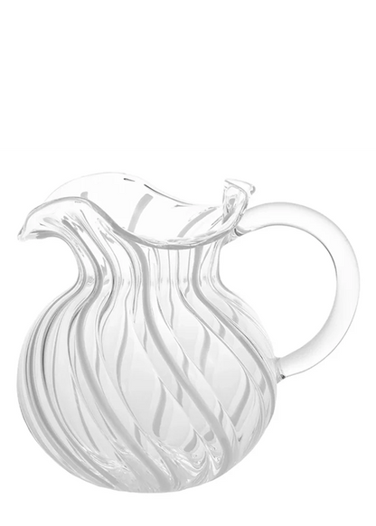 Clear glass pitcher with wavy design on a white background