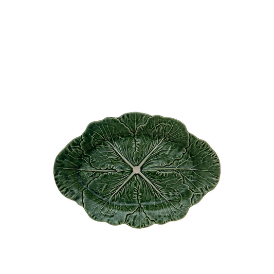 Green ceramic leaf-shaped plate on a white background