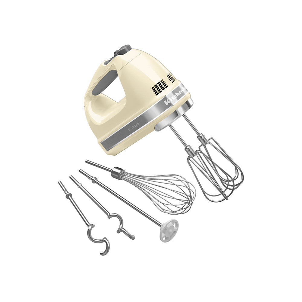 Cream-colored hand mixer with attachments on a white background