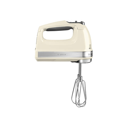 Cream-colored hand mixer with whisk attachment on a white background