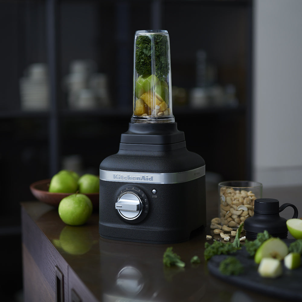 Black KitchenAid blender with ingredients on a kitchen counter