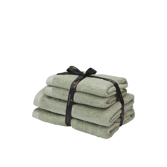 Stack of green towels tied with a black ribbon on a white background
